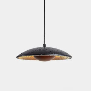 Orvian travertine pendant light overhead close-up showing black speckled stone texture with warm interior glow