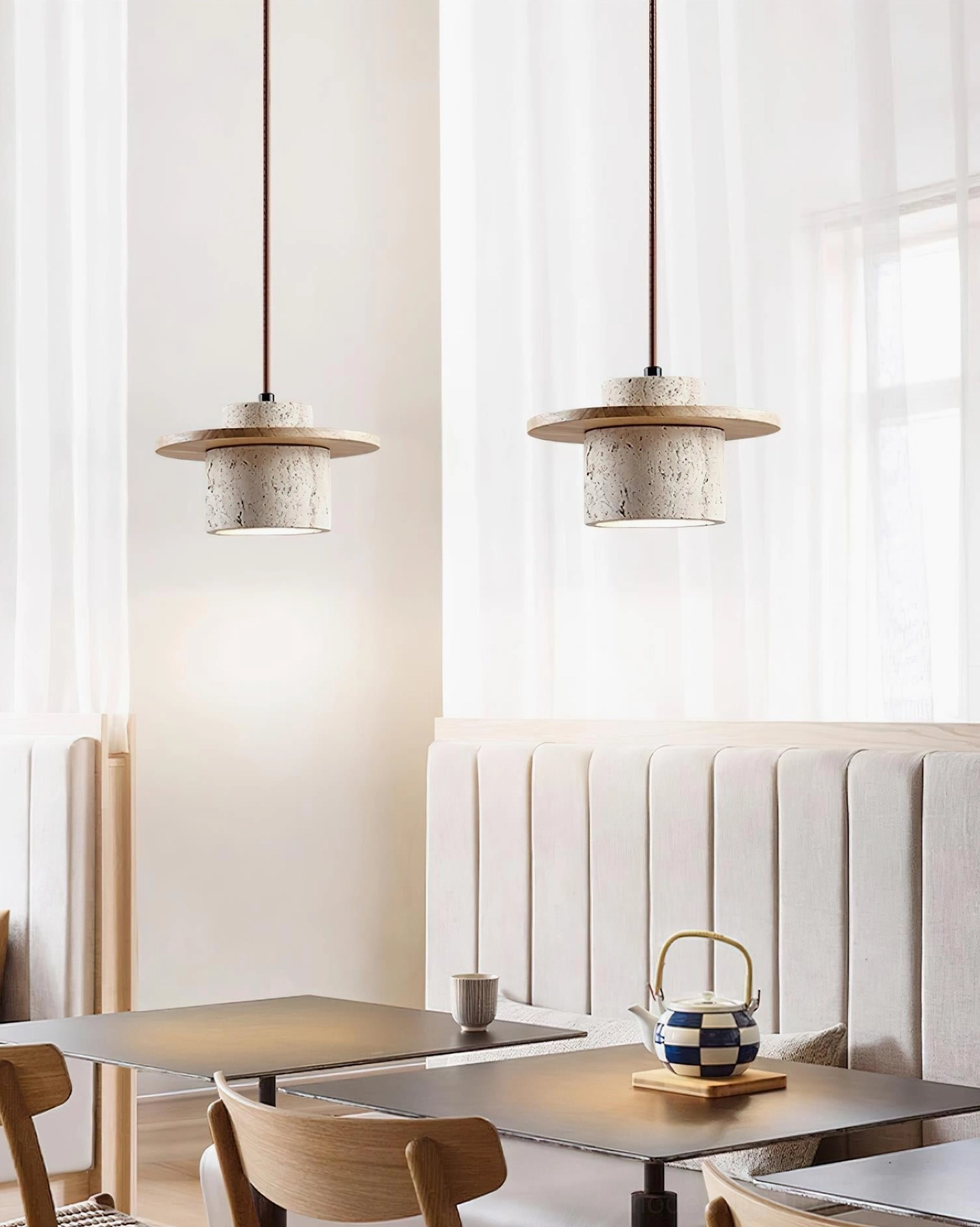 Travertine pendant light in residential interior, mixed material pendant with stone shade and wood elements in modern space