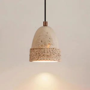 Baskra pendant light side angle displaying copper cord fitting and speckled travertine stone texture