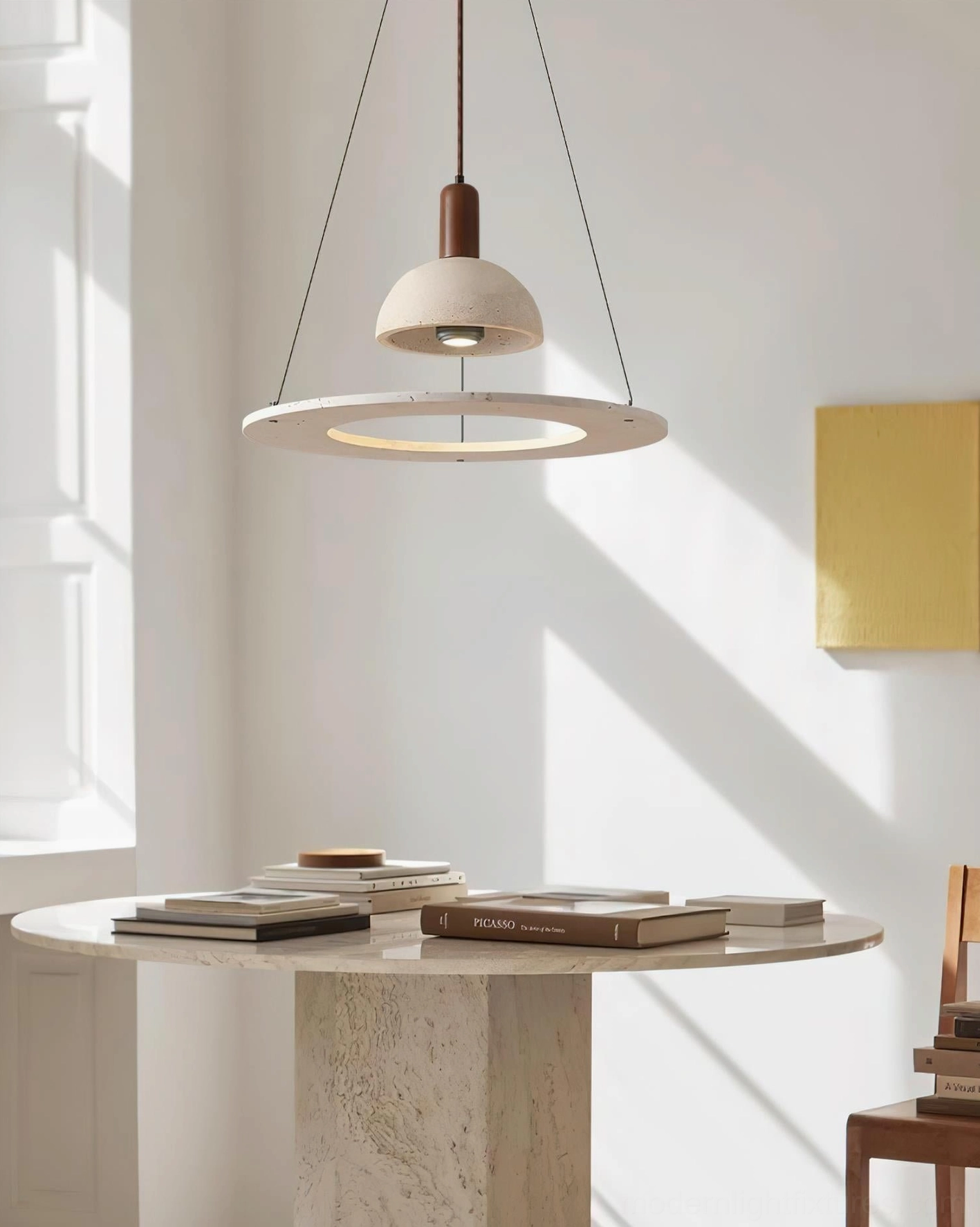 Side view of travertine pendant light fixture with natural stone surface and offset ring design