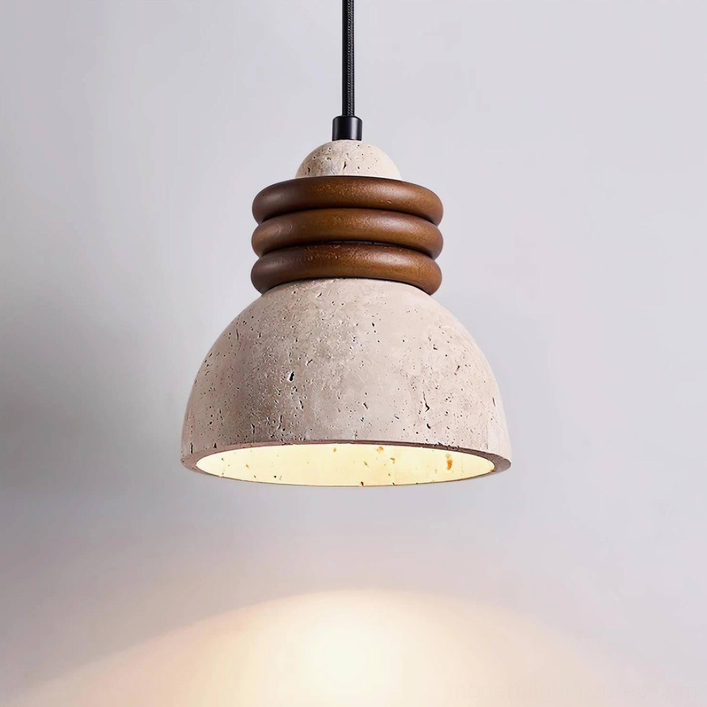 Single travertine pendant light minimalist design with walnut wood accent rings and warm downward light distribution