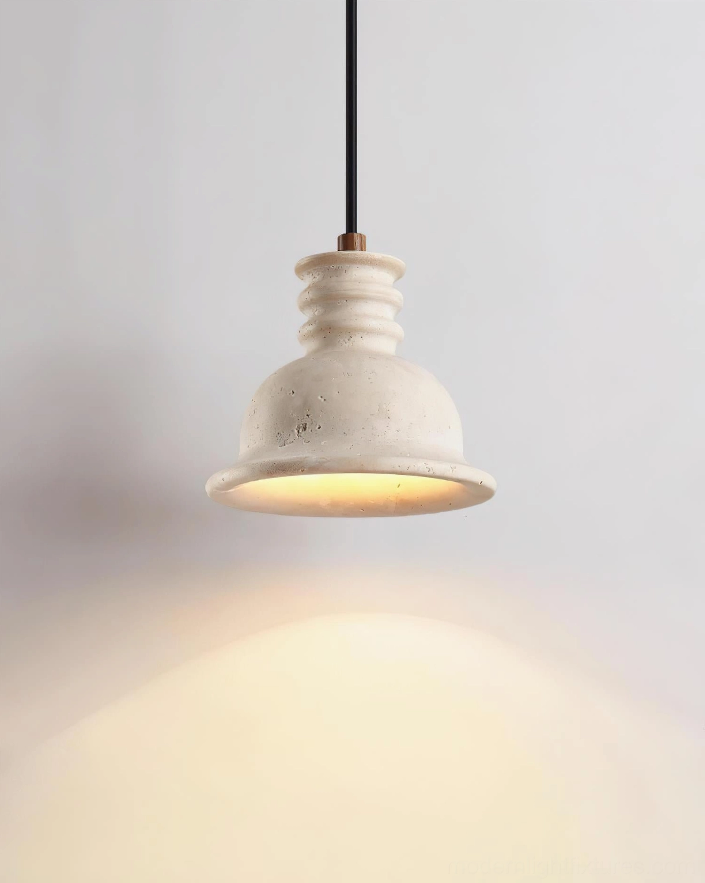 Travertine pendant light detail shot emphasizing natural stone craftsmanship, texture, and premium material quality