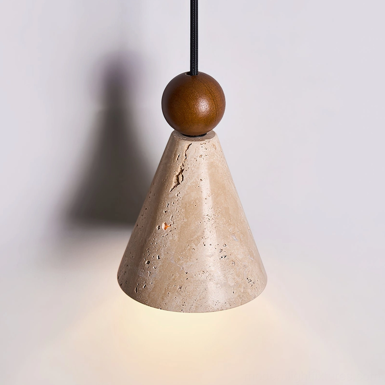 Natural travertine texture detail on cone pendant shade with walnut wood collar detail