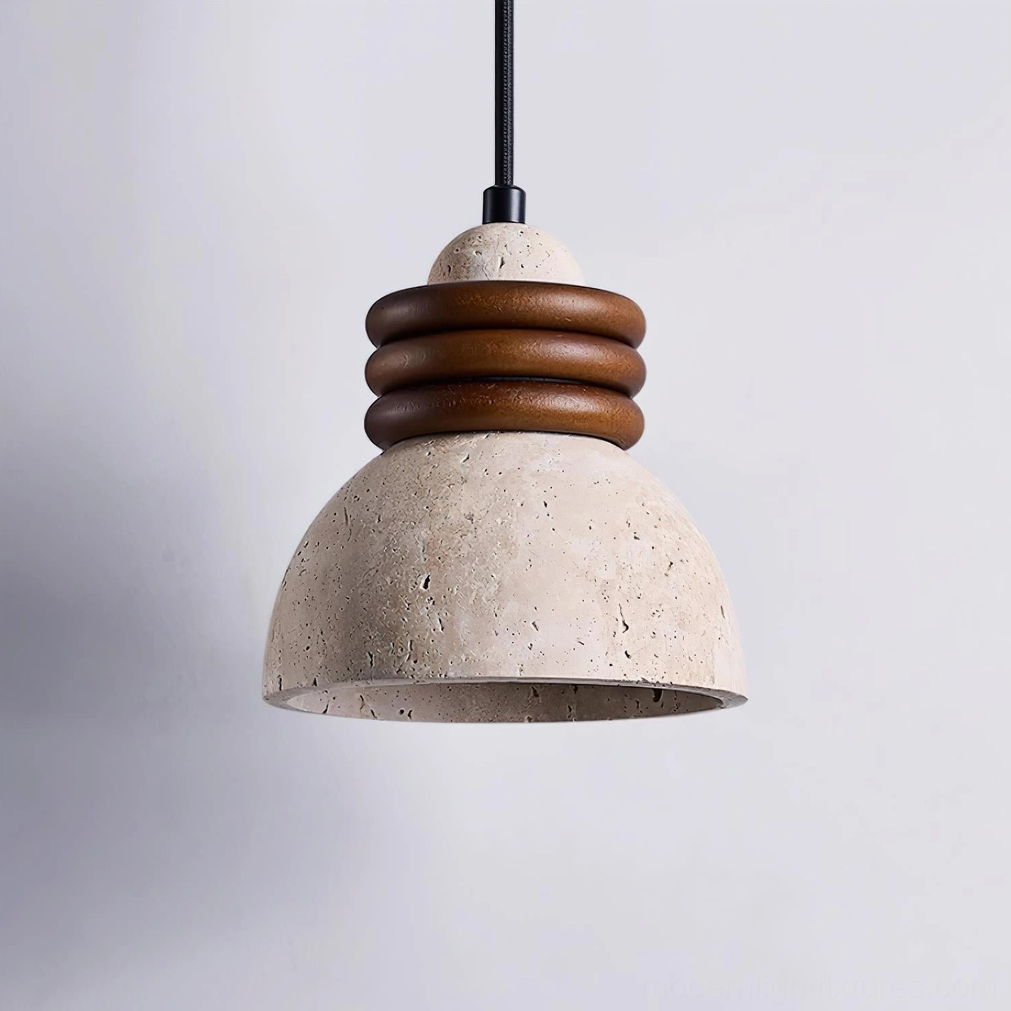 Travertine pendant light side profile showing three walnut rings and black hanging cord against neutral backdrop