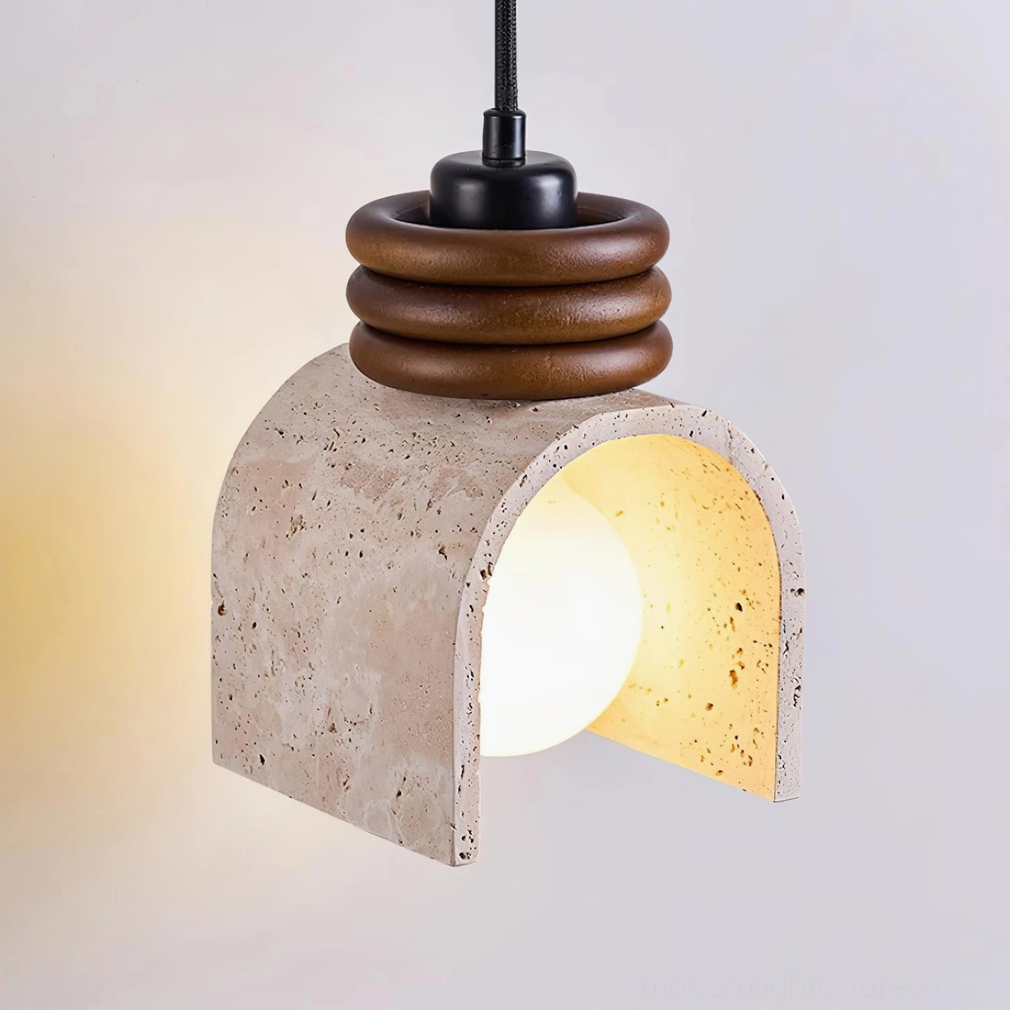 Three-quarter angle view of travertine arched pendant lamp showing porous stone shade, multi-layer brown wood accents, and warm ambient glow for modern minimalist interiors