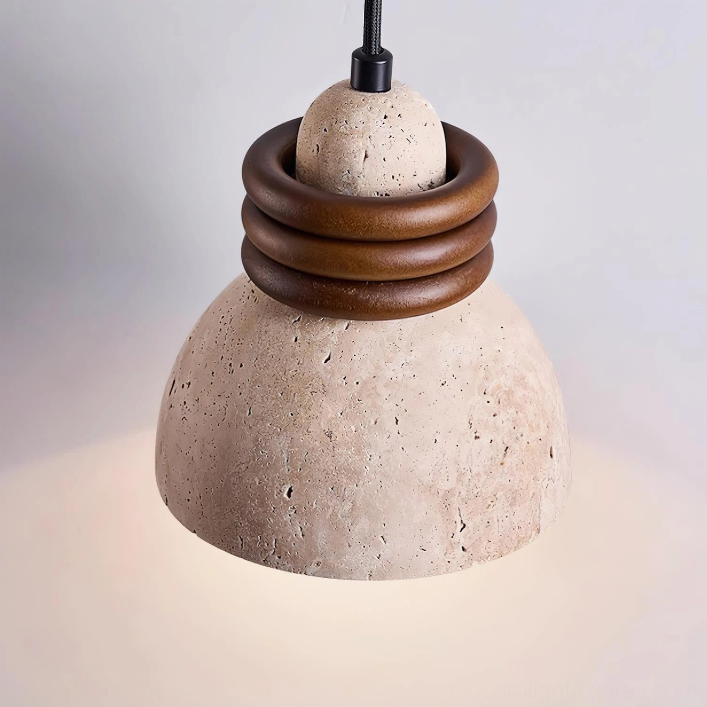 Large travertine pendant fixture close-up low angle view with three walnut wood rings and porous stone surface detail