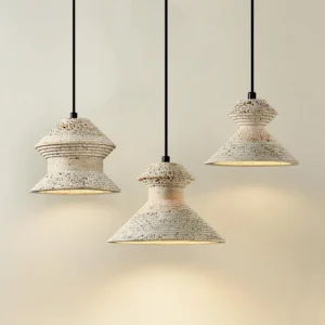 Three-piece travertine pendant light set showing all model sizes arranged together against warm neutral wall