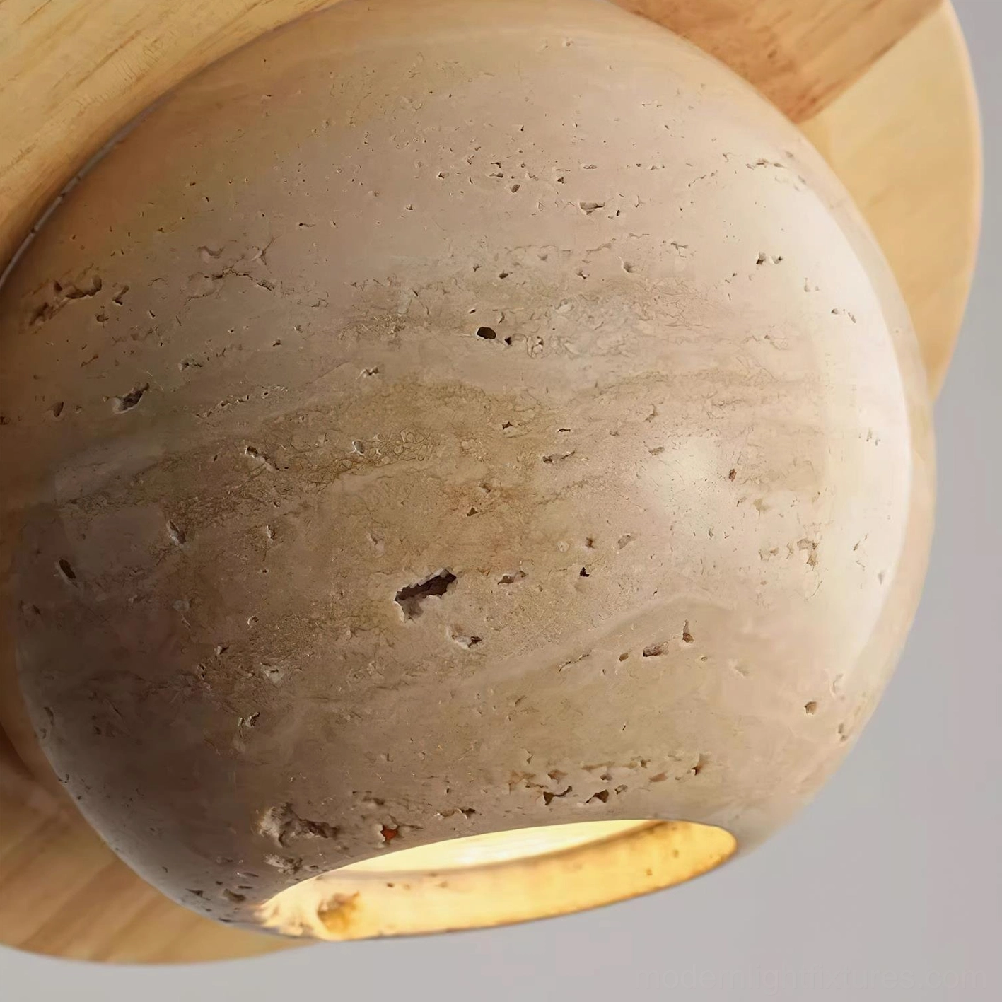 Travertine sphere pendant light in transitional interior setting, blending wabi-sabi aesthetics with contemporary design