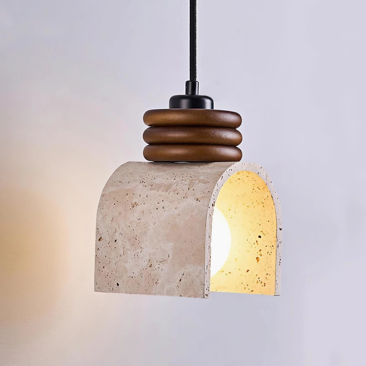 Arched travertine stone pendant light with three-layer wooden ring hardware and warm glowing incandescent bulb, natural rustic wabi-sabi style lighting fixture