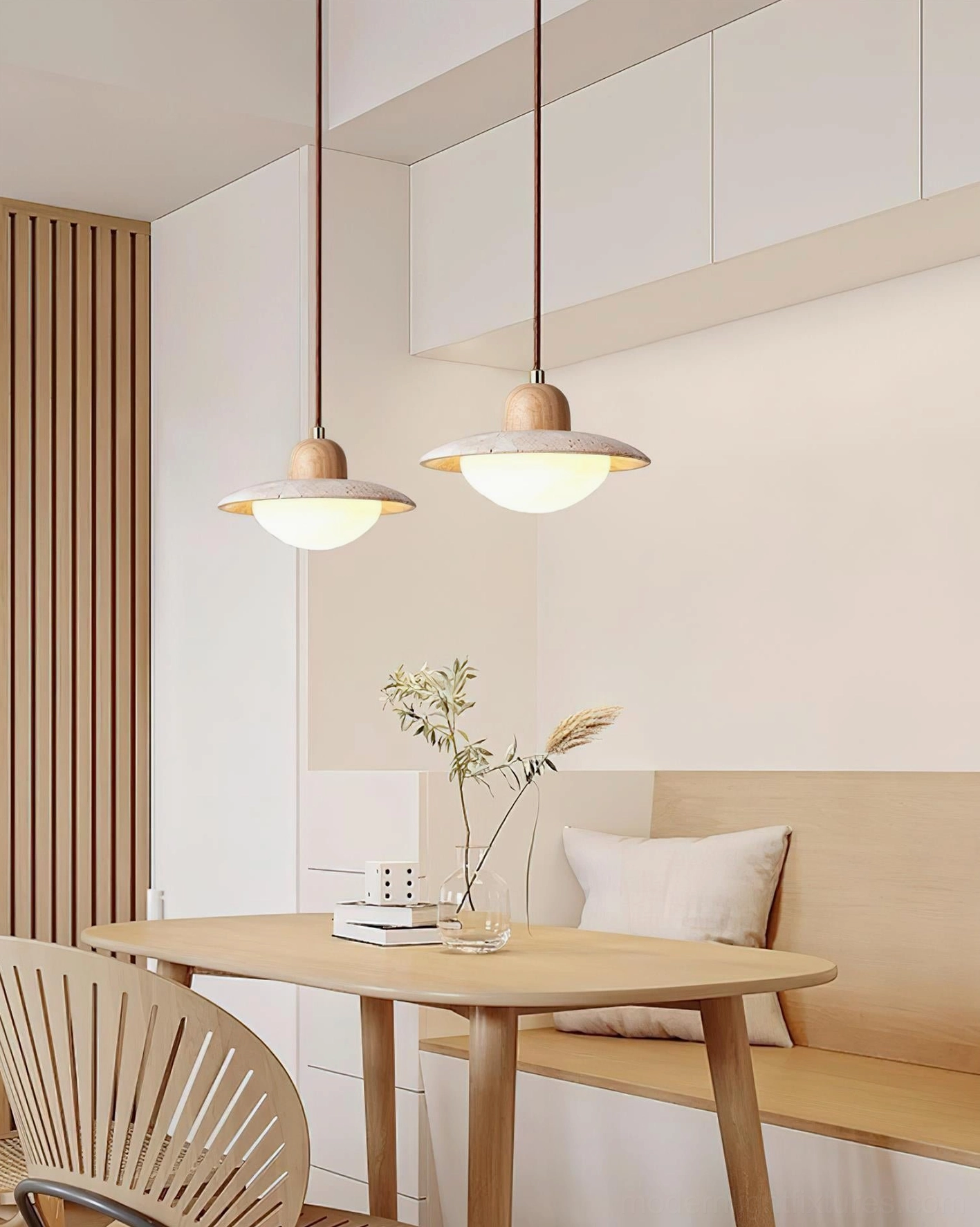 Dual travertine UFO pendant lights over Japandi dining table setup