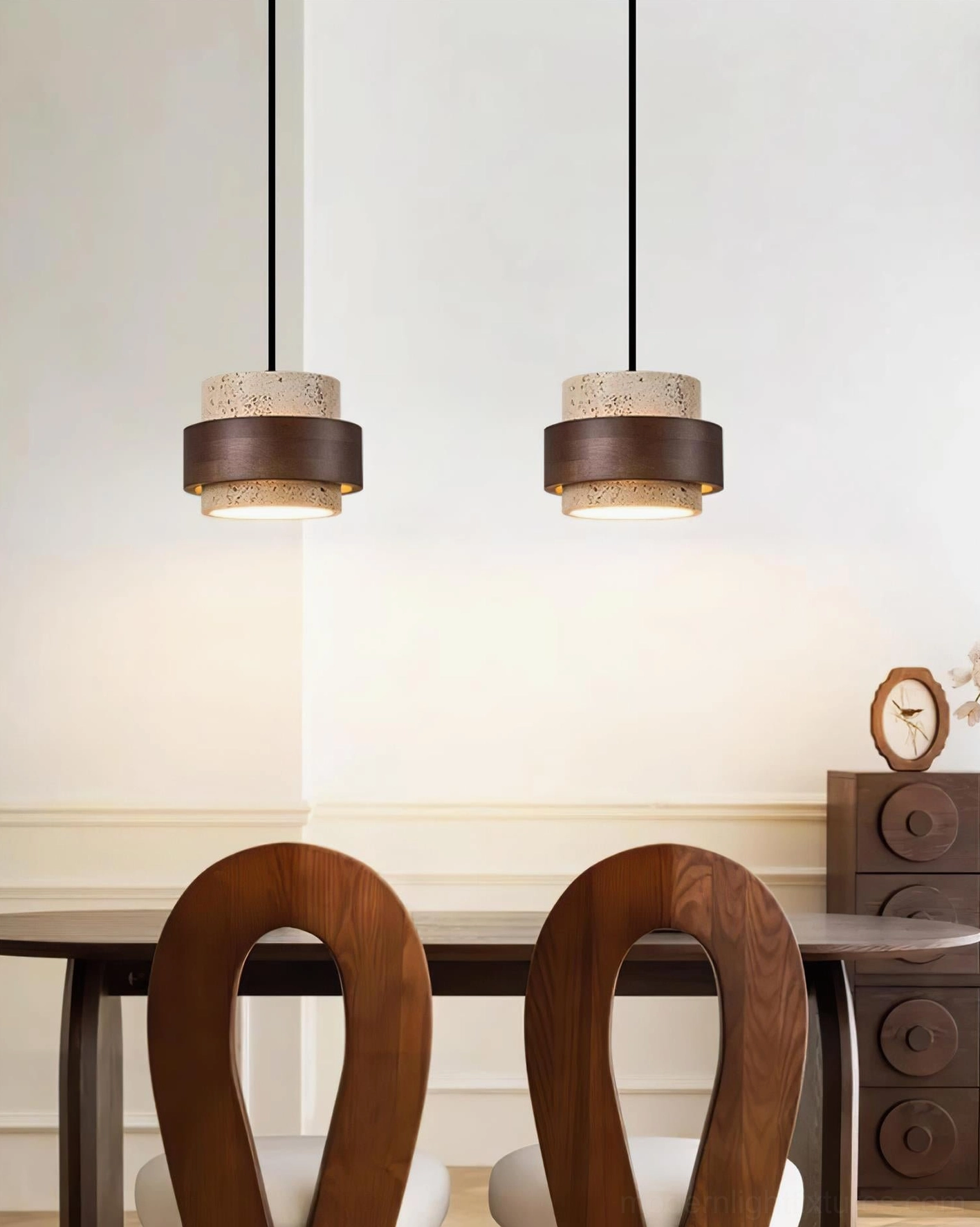 Dual travertine pendant lights installed in contemporary dining area above wooden table