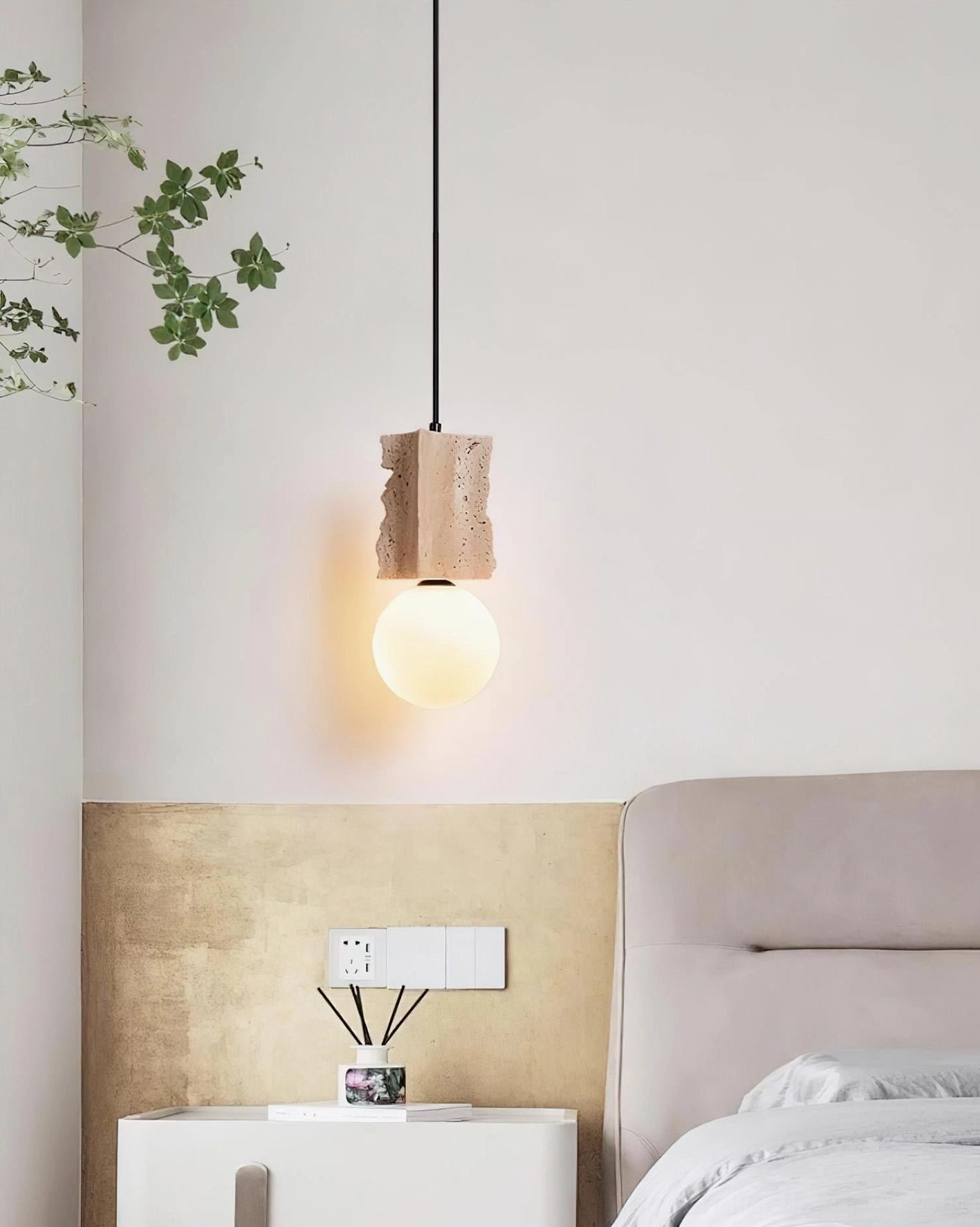 Side profile of travertine globe pendant demonstrating proportional dimensions and sculptural stone base geometry