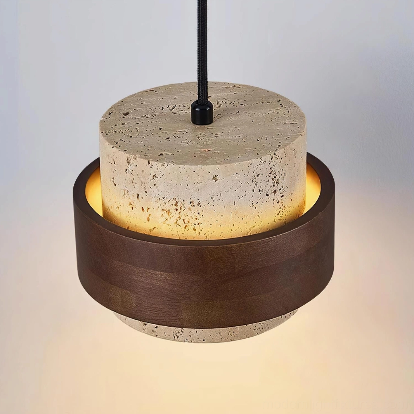 Close-up overhead angle of travertine pendant with natural stone patterns and walnut wood band illuminated