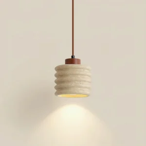 Travertine stone pendant light emitting warm ambient glow, angled perspective showing ribbed texture detail and illuminated warm light