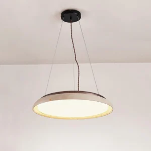 Natural stone travertine pendant light suspended from dark twisted cord in minimalist residential ceiling - warm ambient lighting for modern dining