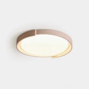 Travertine round ceiling light with notched edge detail, minimalist design, front view against white wall