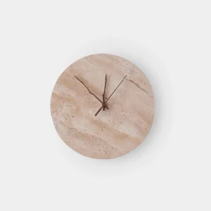 Round travertine clock wall sconce with dark wood clock hands on white studio background
