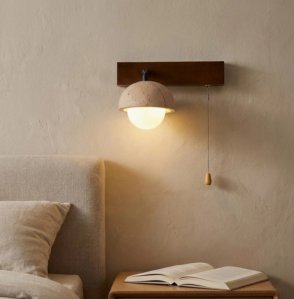 Bedroom bedside wall sconce providing warm ambient lighting above nightstand with open book
