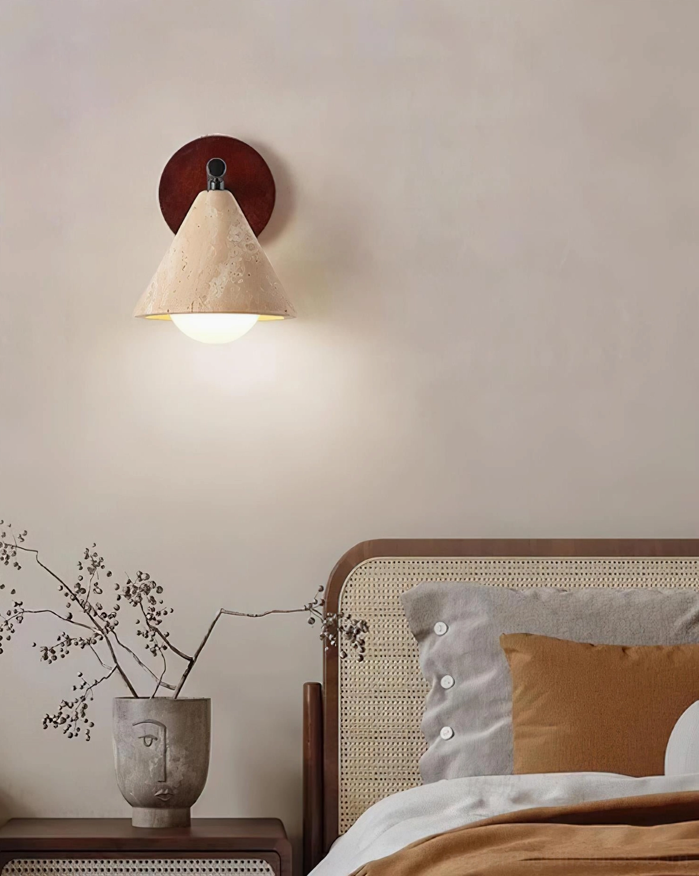 Travertine stone wall sconce mounted on wabi-sabi bedroom accent wall