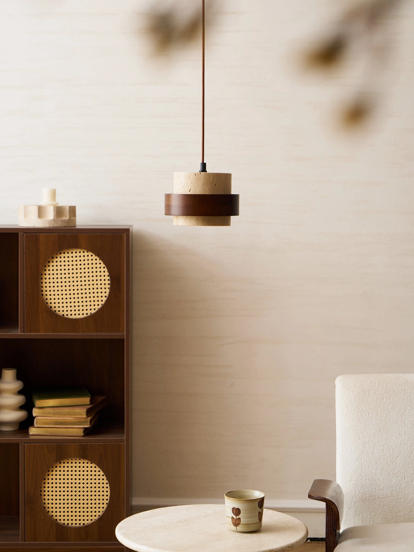 Travertine stone pendant lamp suspended in contemporary dining space, architectural lighting focal point