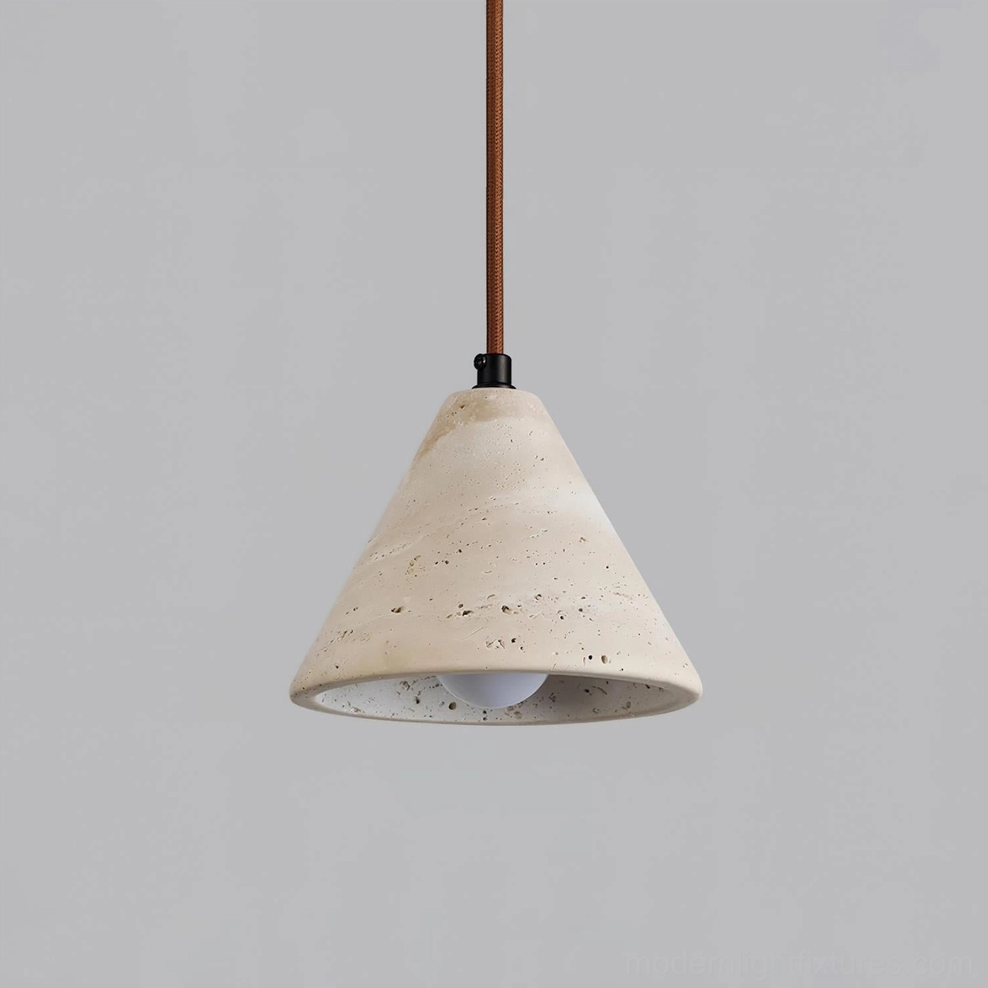 Contemporary travertine pendant light showcasing exposed bulb interior with raw stone surface details