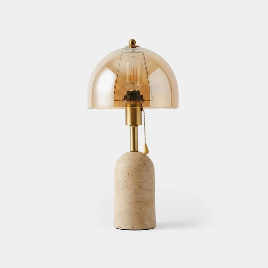Travertine table lamp with amber glass dome shade and brushed brass stem on white background