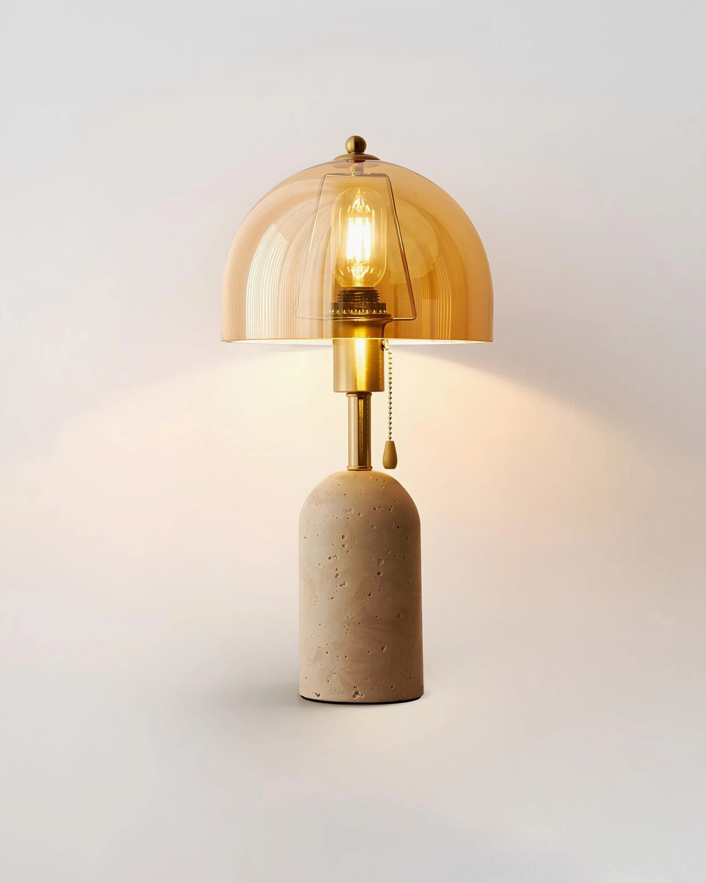 Close-up detail of travertine base texture and brushed brass stem construction