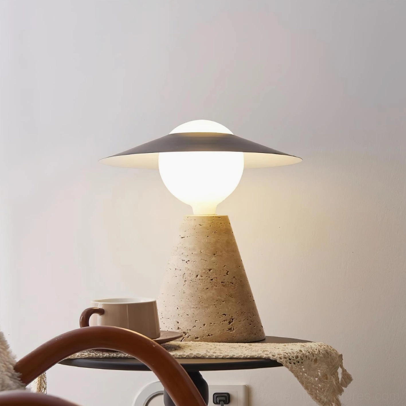 Contemporary travertine stone table lamp on bedside table in bedroom setting