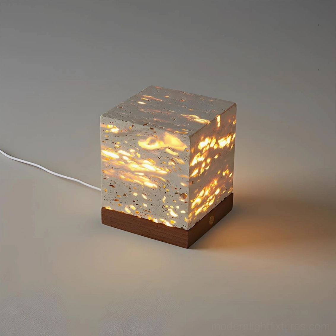 Travertine cube lamp low angle front view minimalist studio design warm light