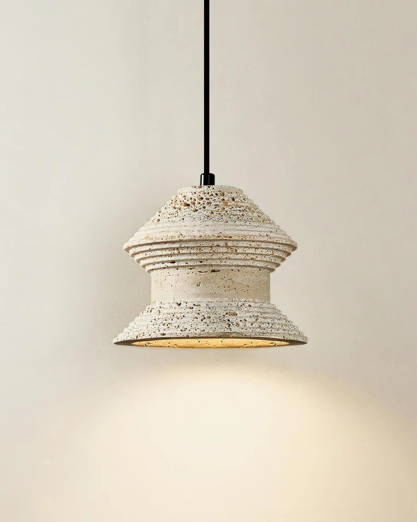 Three-head travertine pendant light cluster above dining table in upscale residential interior design
