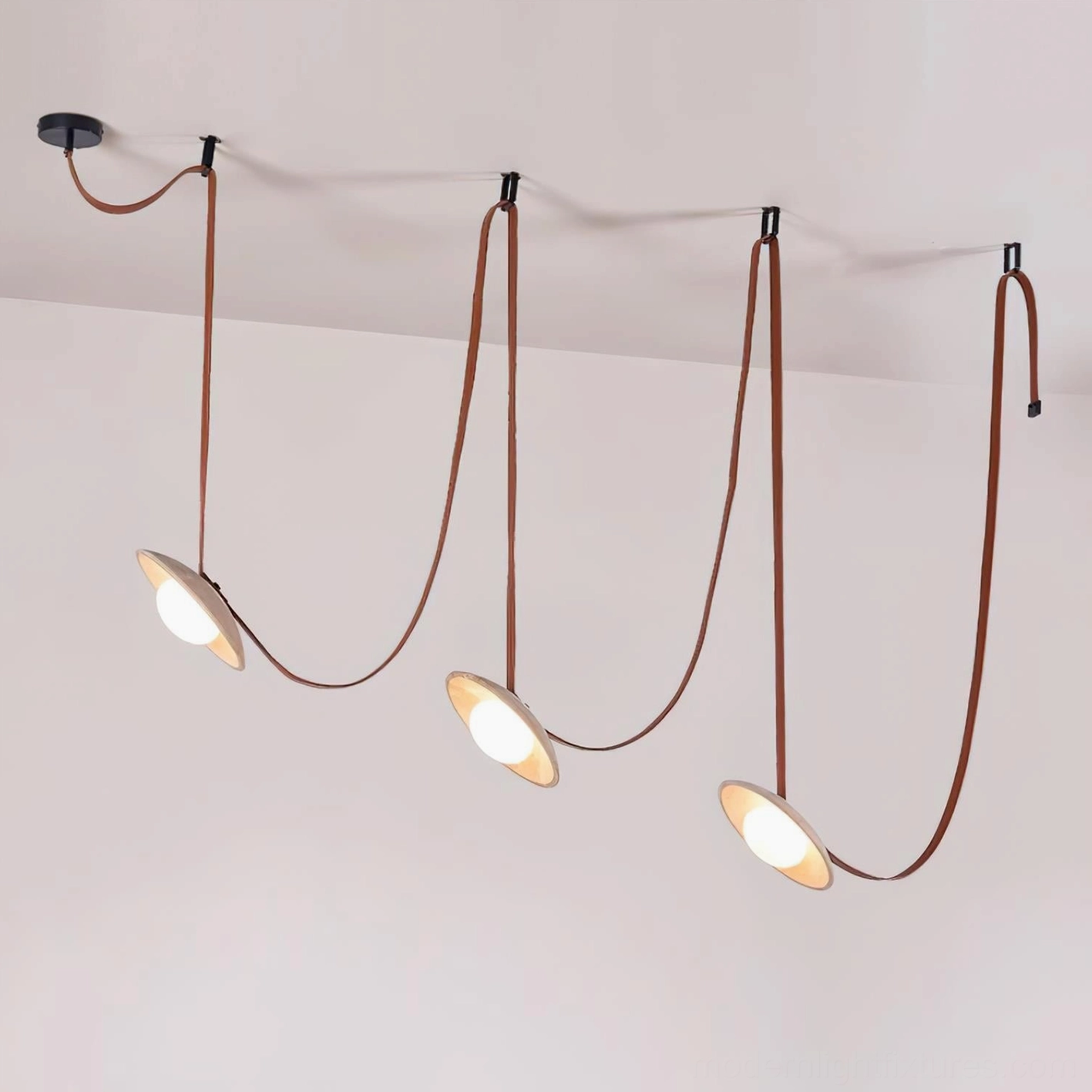 Three head travertine chandelier in red leather and beige finish, overhead front studio perspective