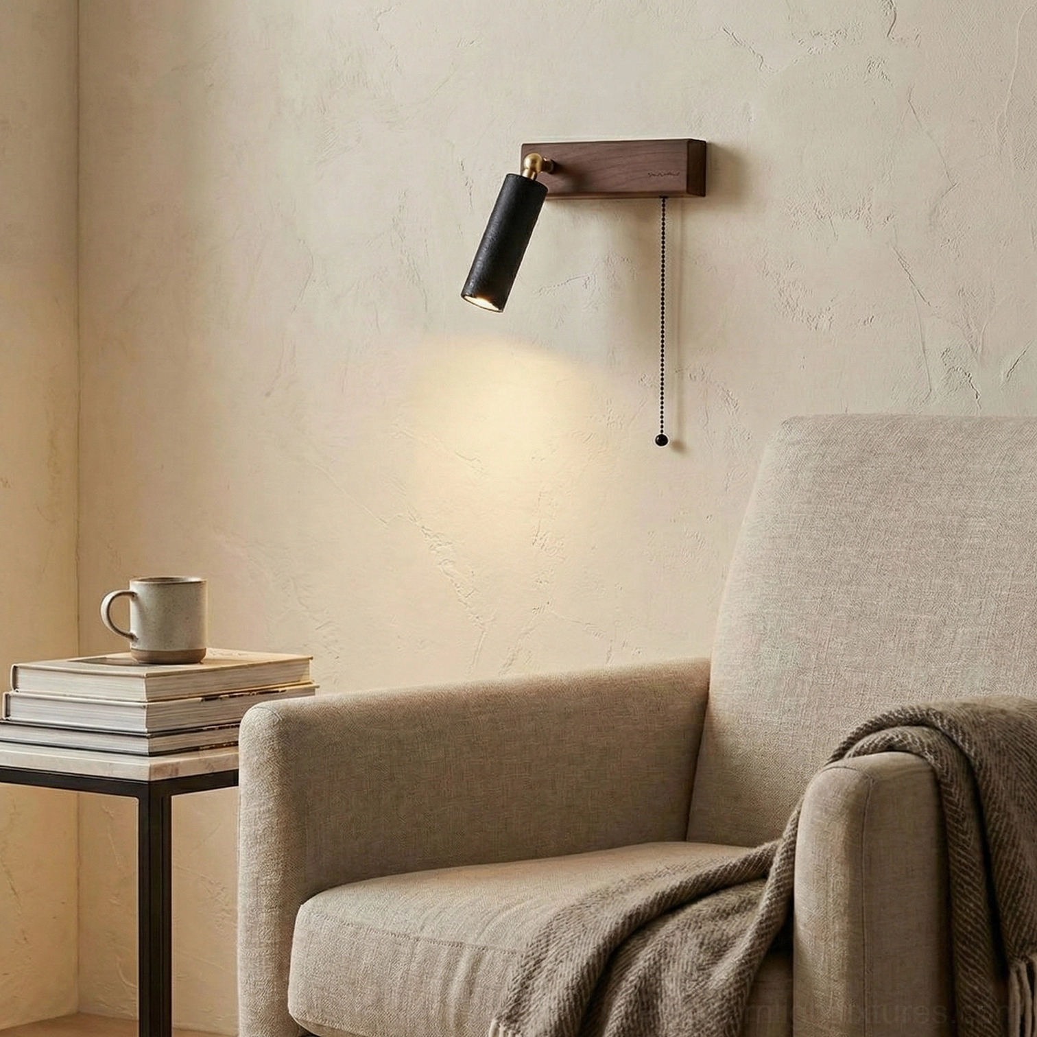 Modern travertine wall sconce with black shade providing warm task lighting in contemporary living room lounge