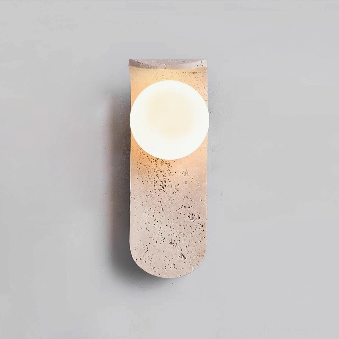 Modern travertine wall lamp with rounded stone mount and frosted glass - studio product shot