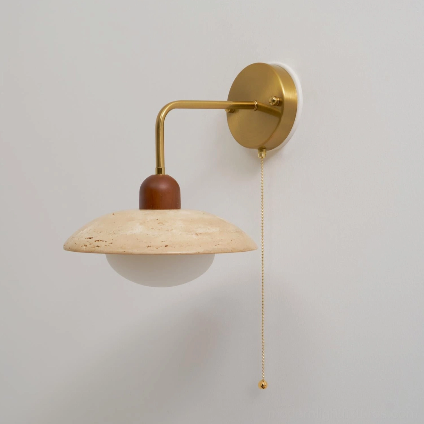 Travertine wall lamp profile showcasing wooden connector between brass arm and stone shade