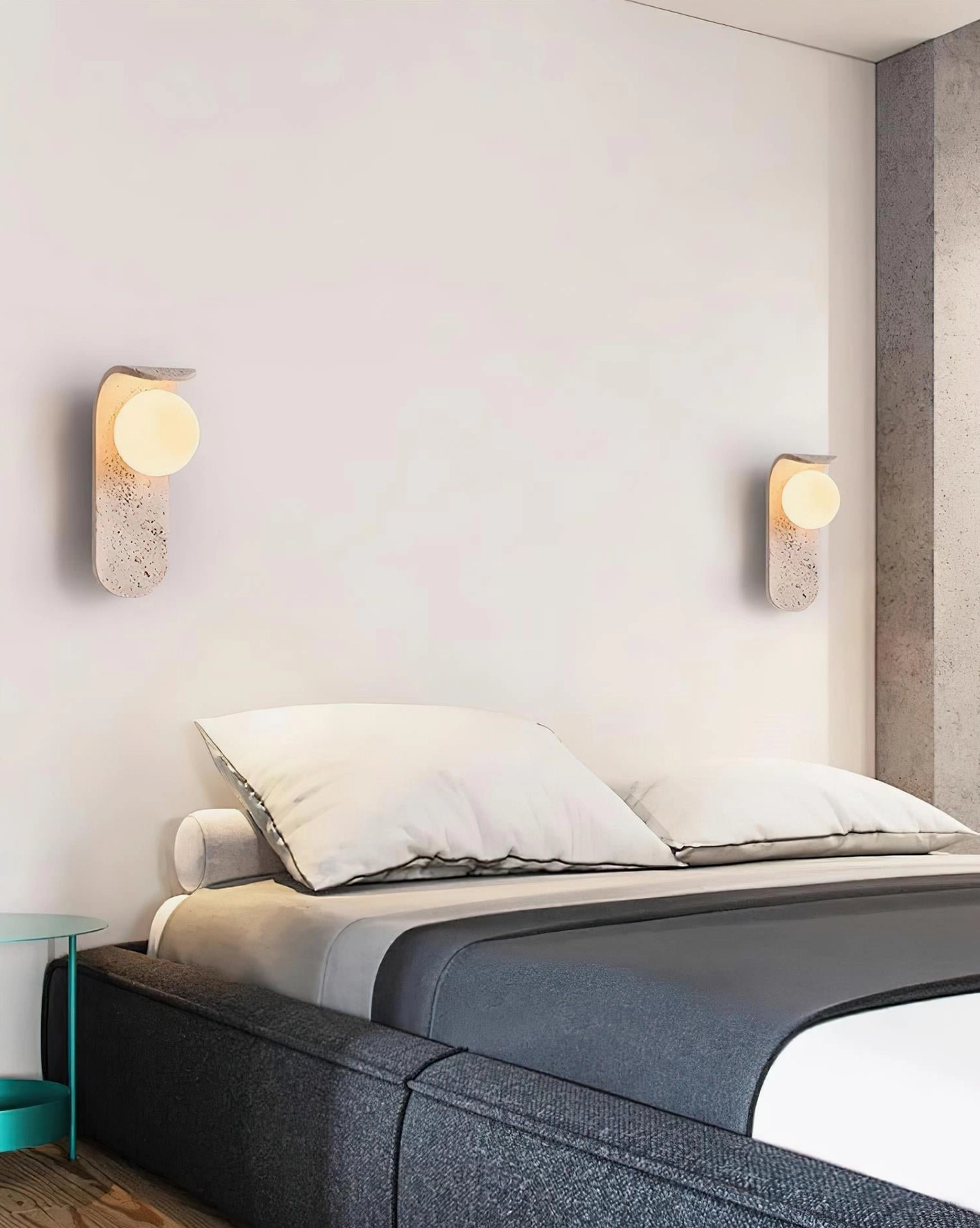 Travertine wall lamp from side angle - showing curved stone base and glass globe design