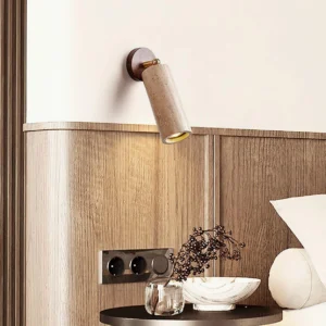 Mireille wall sconce installed in bedroom bedside ambiance with warm downlight on wooden panel wall