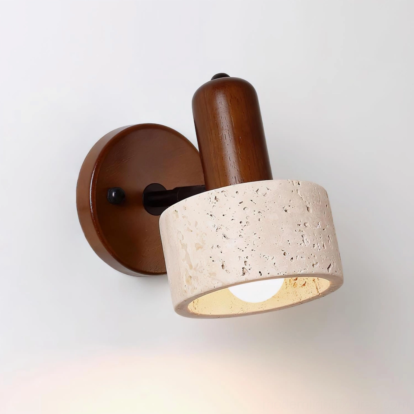 Travertine wall sconce in bedroom setting providing soft directional bedside reading light