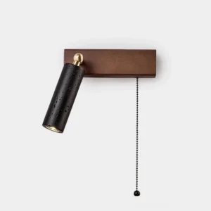 Travertine pull chain wall sconce with black porous stone shade, walnut wood backplate, and brass rotating joint – studio product display