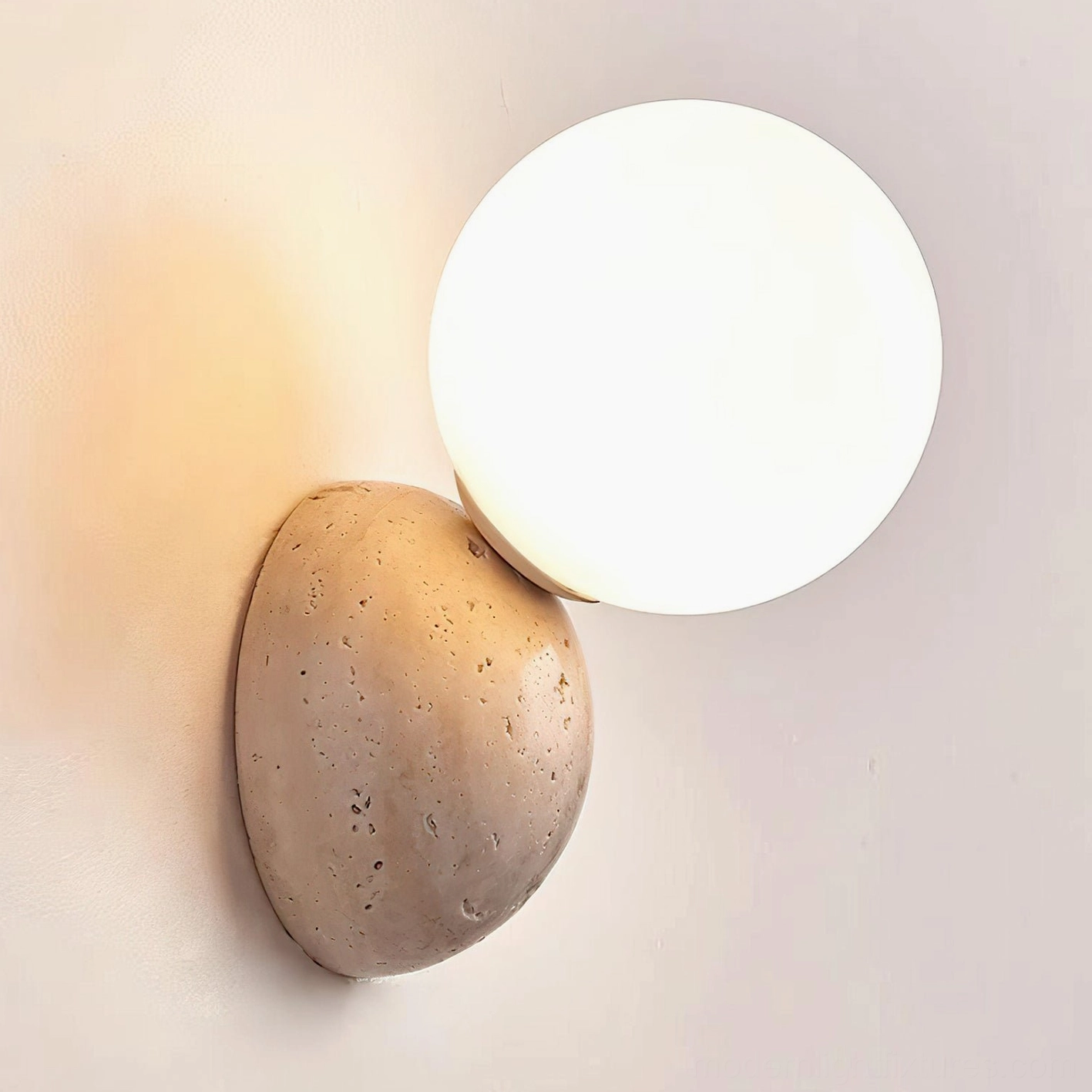 Close-up travertine wall sconce showing natural stone porous texture and frosted glass diffuser detail