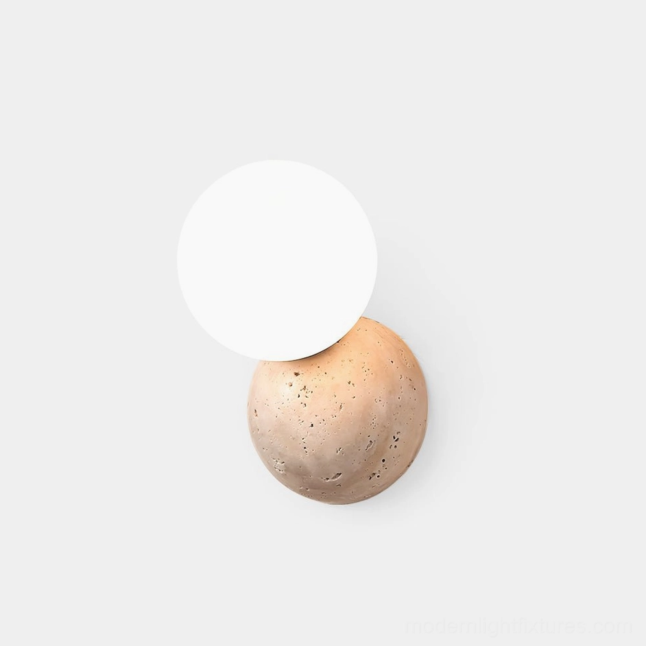 Travertine stone wall sconce with frosted glass globe, front view on white background, minimalist modern design