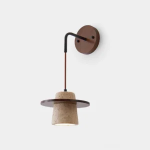 Travertine wall sconce with wood accents front view on white background showing sculptural modern design