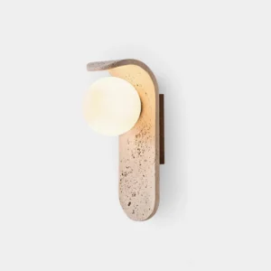 Travertine wall sconce with frosted glass globe - front close-up detail showing porous stone base and minimalist design