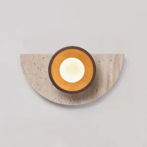 Contemporary wall lamp with warm light glowing through frosted glass sphere, highlighting layered circular wood trim and organic stone texture
