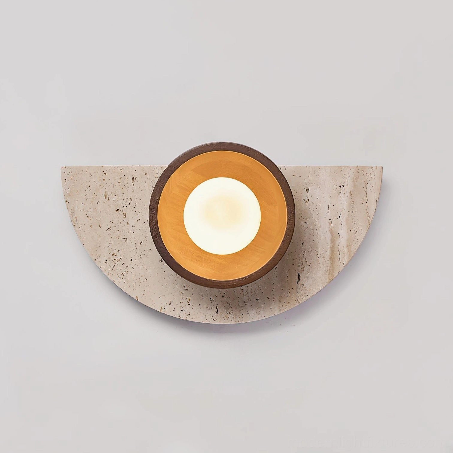 Contemporary wall lamp with warm light glowing through frosted glass sphere, highlighting layered circular wood trim and organic stone texture
