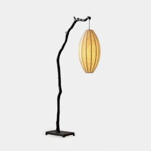 Modern tree branch floor lamp with matte black metal stand and yellow fabric lantern shade in studio setting