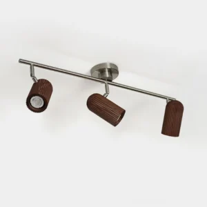 Trevio three-head track ceiling light fixture with silver metal rail and dark brown ribbed wooden shades, front studio view