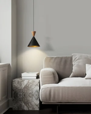 Trevio pendant lamp installed in modern living room beside fabric sofa and marble side table, warm ambient downlighting illumination