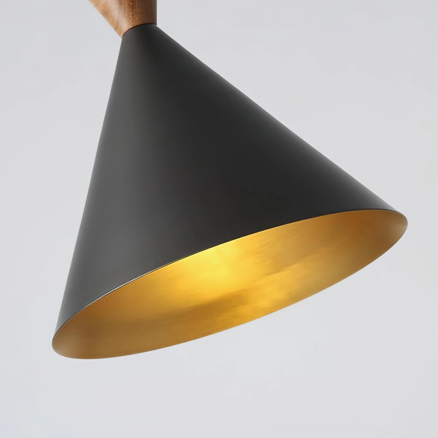 Close-up detail of Trevio pendant lamp conical shade showing brushed gold metallic interior and matte black exterior finish