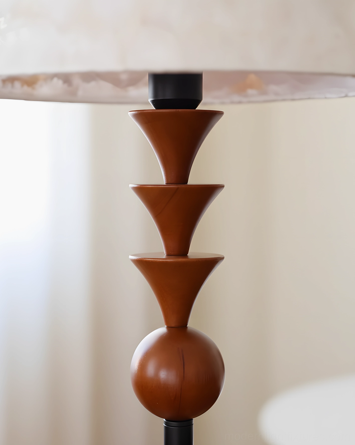 Close-up detail of Triad Peak lamp showing stacked wooden cone and sphere accents with fabric shade