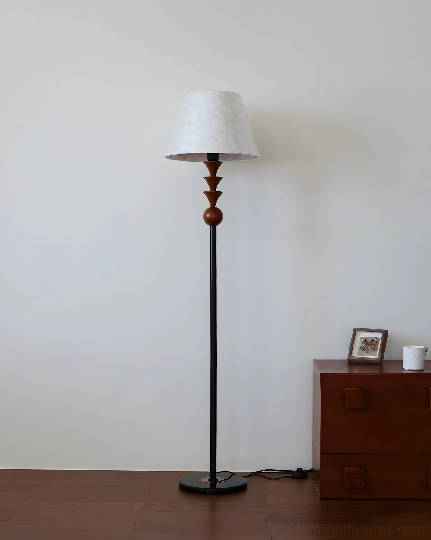 Modern floor lamp with fabric shade and turned wood accents in Scandinavian minimalist setting